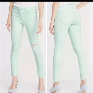 Mint green distressed skinny jeans